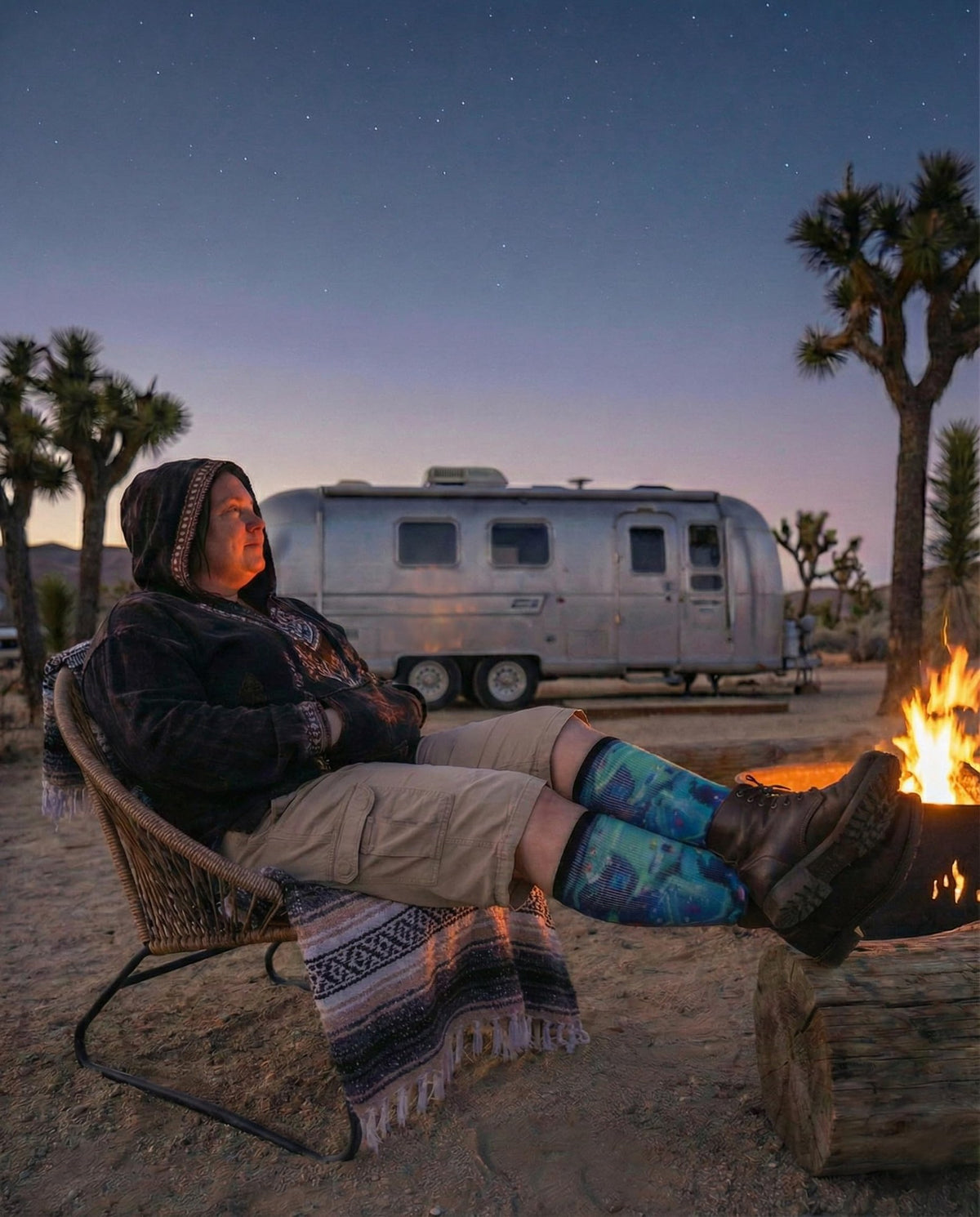 Person relaxing by a campfire in Gooi Cat UFO extra wide socks, roomy non-binding fit