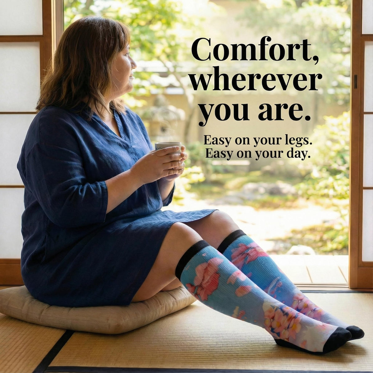 Woman with tea on a tatami floor in Gooi Cherry Blossom extra wide socks, easy on your legs