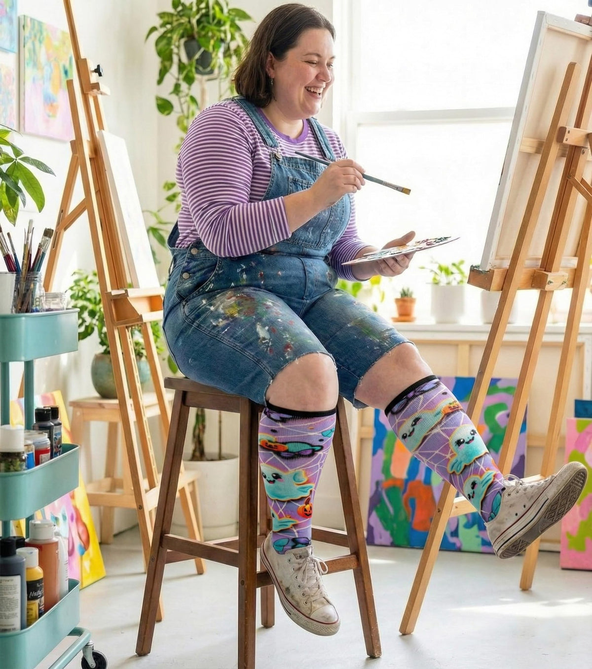 Woman painting in Gooi Halloween extra wide socks, roomy non-binding knee-high fit